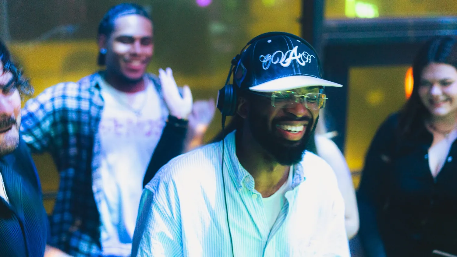 DENBO smiling behind the decks in the crowd